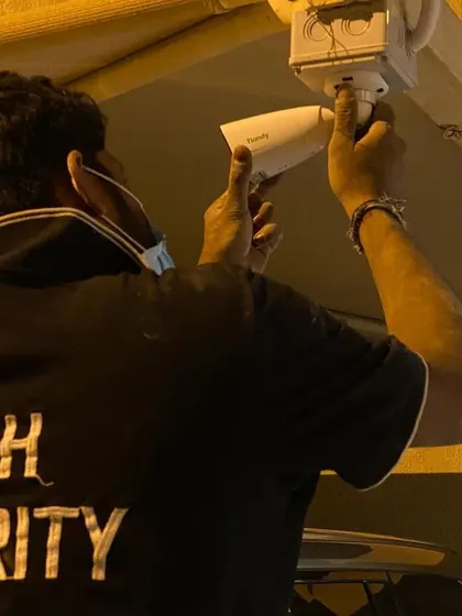 Working at night to get the job done. This is a close-up of me adjusting a bullet camera for optimal viewing angle and night vision performance.