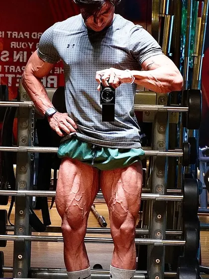 A full shot of my vascular and defined legs. This is the result of never skipping leg day and always taking the chance to push harder.