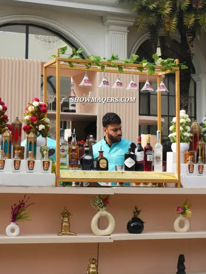 A bartender at a dedicated bar station, ready to serve guests. We manage all aspects of beverage service.