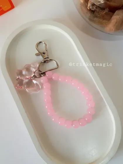 This pink beaded charm with a butterfly accent is handmade and full of love. It's a simple yet beautiful way to personalize your bag or keys.