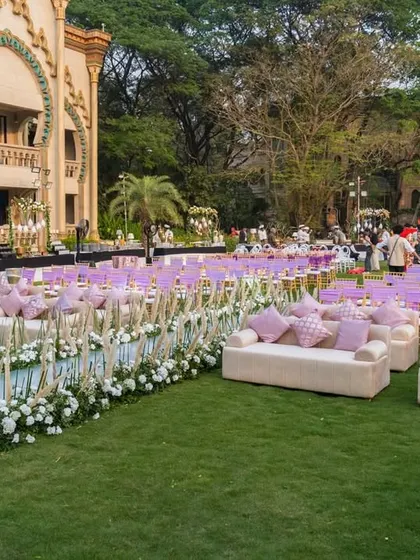 I arranged comfortable and stylish lounge seating for guests on the lawn. The plush white sofas with pink and patterned cushions provided a relaxed space to enjoy the outdoor celebration.