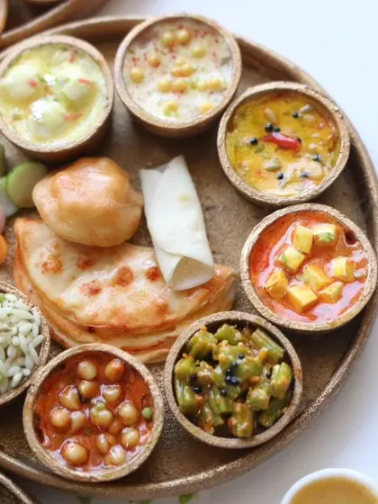 A close-up of a North Indian thali, showing the detail in each of the tiny bowls of curry and rice.