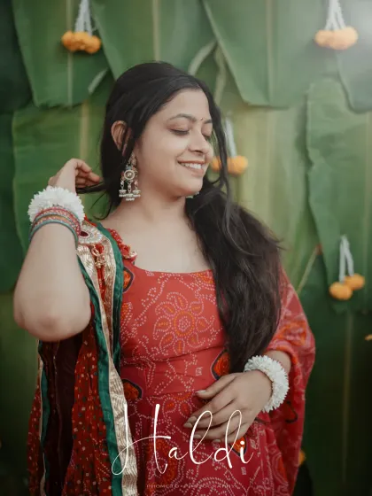 An artistic portrait of the bride, the word 'Haldi' elegantly overlaid, making for a perfect album cover shot.