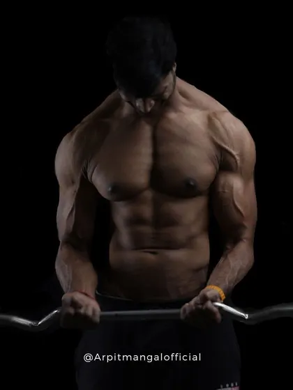 Isolating the Biceps. A photo demonstrating a barbell curl with intense focus, highlighting the importance of controlled movements in strength training.