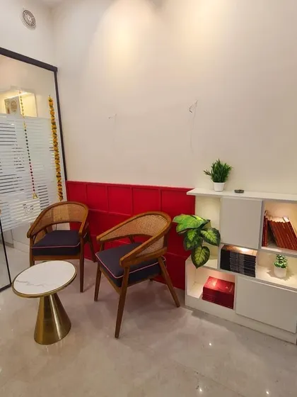 The waiting area in my new office is designed to be welcoming and calm. The use of red adds a touch of energy, while the comfortable seating and plants create a positive first impression for clients.
