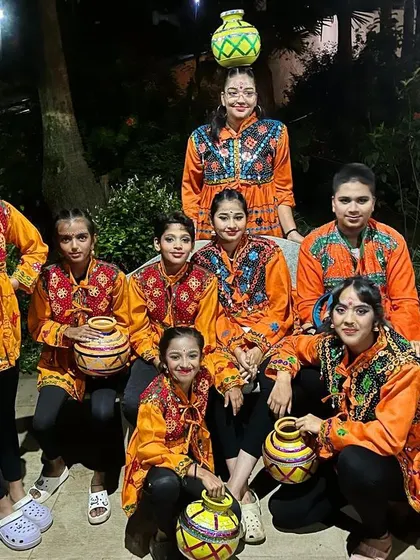 Another pose from our talented dance team. The props, costumes, and confident smiles show they are ready to perform.