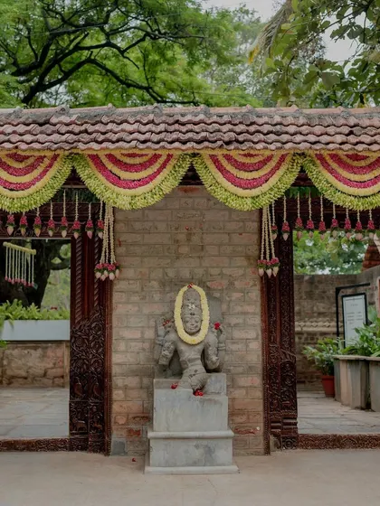 An entrance decorated with traditional floral 'thorans' or garlands.