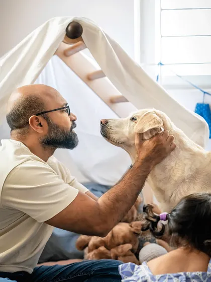 Sometimes the best photos happen in the quiet moments at home. For Shelby's 10th birthday, we built a simple fort and let the family just be together. This image of a father and his loyal dog sharing a look of pure understanding is why I do what I do.