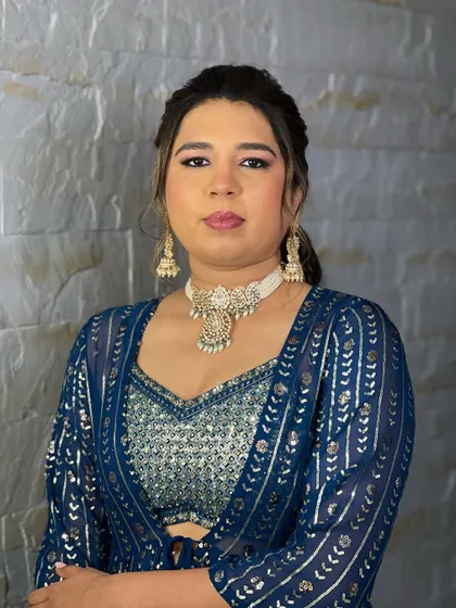 A close-up of a client wearing a beautiful pearl choker with a kundan pendant. This lightweight rental is perfect for an engagement or reception look.