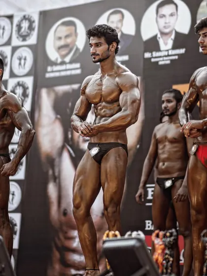 Waiting for the judges' decision on stage. This is the culmination of months of dedication, from the diet for fat loss to the final posing routine.