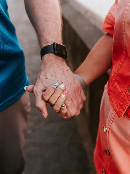 Sometimes the smallest details tell the biggest story. A close-up of them holding hands, a simple gesture of connection and years of shared life.