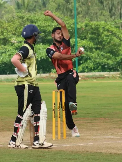 A fast bowler in full stride during a youth match.