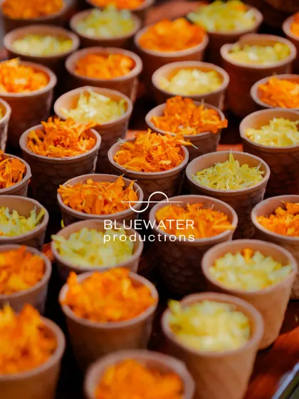 For a Haldi ceremony, small paper cups are filled with fresh marigold petals, ready for guests to shower the couple with blessings.