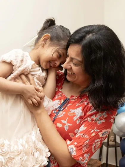 A sweet, candid hug between a mother and daughter during a birthday celebration. These are the priceless memories I strive to capture.