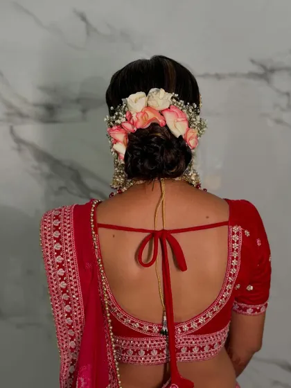 The back of this bridal blouse is as stunning as the front, perfectly complemented by the floral hair bun. Every detail matters for the complete look.