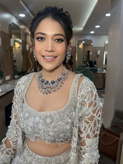 A soft glam look for this client in a beautiful silver lehenga. The makeup is understated and elegant, perfect for a sophisticated event.