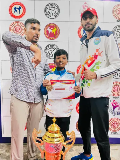 With one of our youngest champions. He fought with incredible determination to win his medal at the state kickboxing championship.
