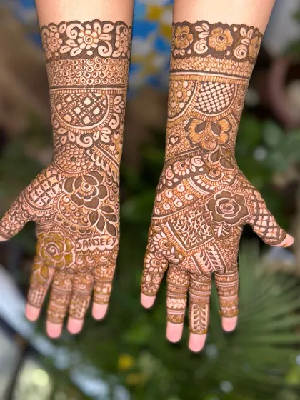 A non-bridal Indian design personalized with the name "Sanjee" on the palm.