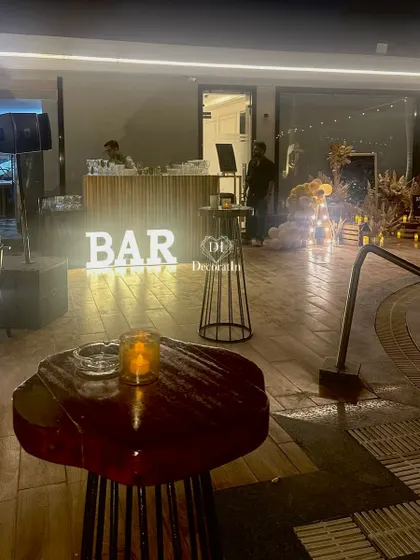 A wider view of the bar area, showing its proximity to the other decor elements and the overall party flow.