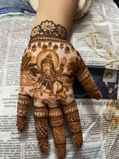 A sweet portrait of Laddu Gopal (baby Krishna) on the palm. This is a lovely design for Janmashtami or for anyone who feels a special connection to him.