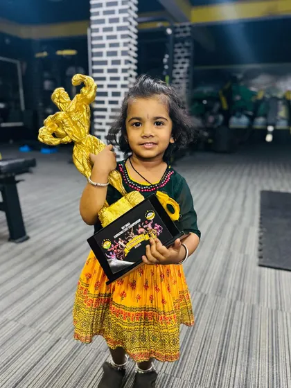 Holding the trophy she helped me win. Her support is my biggest prize. We teach children that celebrating each other's success is just as important as their own.