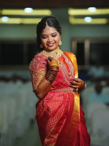 Ready for her reception in a gorgeous red silk saree. I created a full-coverage, glamorous look with matching jewelry that ensures she will be the star of the evening.