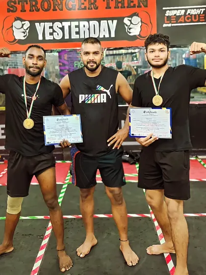 Two of my fighters with their gold medals and certificates. They are proof that our training methods produce results.
