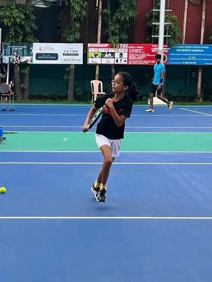 A junior player demonstrates excellent footwork and balance as she moves to a wide ball. Agility and court coverage are key components of our junior development program.