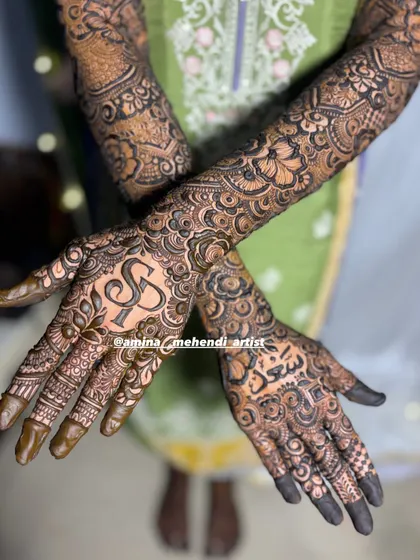 A close-up of a nikah mehendi with the couple's initials 'SS' and the groom's name 'Saad' in Urdu script.