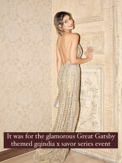 A full-length shot of the retro-glam look, showing the backless design of the dress and the sophisticated styling.