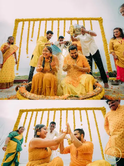The couple getting drenched with water by their friends during a fun-filled beach Haldi ceremony.