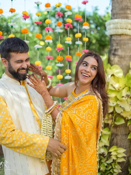 A playful moment during their Haldi portraits. Her teasing gesture and his big laugh show the fun and easygoing nature of their relationship.