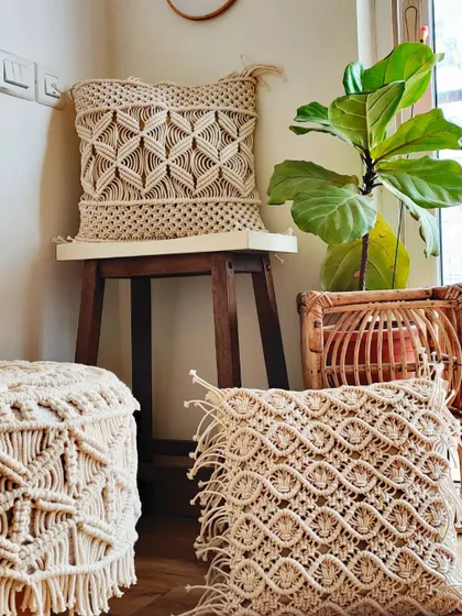 A corner of a cozy room, featuring my macrame stool and cushion covers.