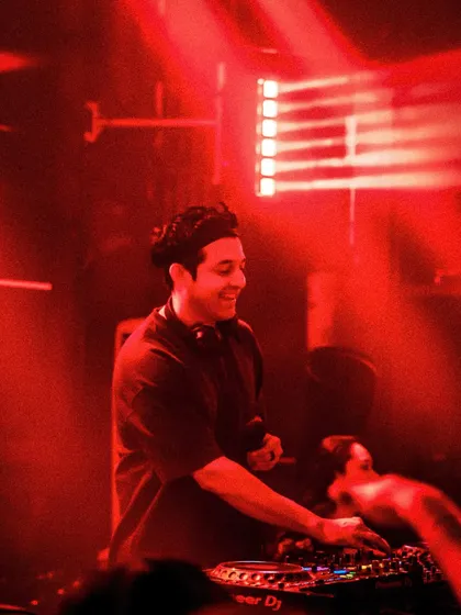 A moody, red-lit shot of me focused on the mix.