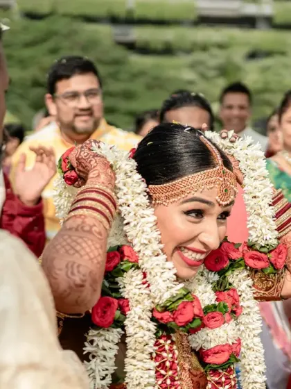 A moment of pure, uninhibited joy from the bride during her South Indian wedding ceremony. Her radiant smile and the candid nature of the shot are simply infectious.