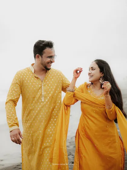 A walk on the beach in coordinated yellow outfits for Aiswarya and Vishnu. Their shared laughter against the serene backdrop makes for a perfect, candid pre-wedding memory.