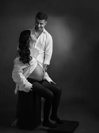 A relaxed and intimate moment between a couple. The simple white shirt styling in this black and white photo creates a timeless, at-home feel even in the studio.