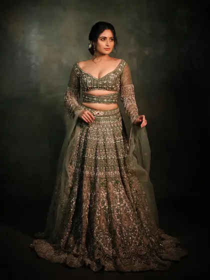 Another full-length portrait showcasing this exquisite green lehenga. The makeup is polished and radiant, completing a look of pure elegance.