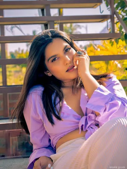 The full look, showing how the subtle purple makeup complements the lavender shirt. It's a great example of how to incorporate color in a wearable way.