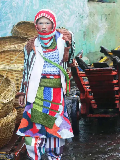 A moment of stillness amidst the chaos of the city. This shot from the "Kaleidoscope" series juxtaposes high-fashion knitwear with a raw, industrial background, creating a story of finding beauty in unexpected places.