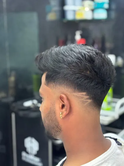 A close-up of a fade with a sharp, geometric line design.