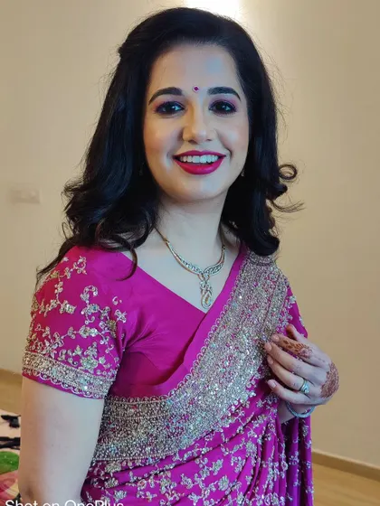 The final look for Priyanka. I gave her classic, soft curls, a bright red lipstick, and defined eyes that make her shine. She looks absolutely ready for her party.