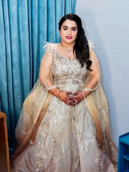 A full-length view of the bride in her stunning Kalki fashion gown. The makeup is bold and beautiful, completing the showstopping look.