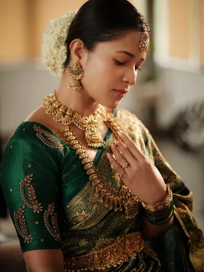 A beautiful portrait from our Navaratri shoot. The model is wearing a classic antique gold temple necklace set that looks stunning with her green silk saree.