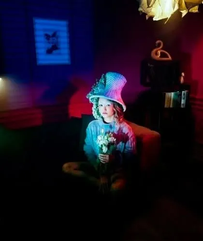 An experimental shoot with a whimsical theme. The makeup is kept soft to work with the colorful, multi-hued lighting and quirky styling of the scene.