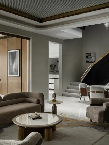 The ground floor of The House of Dancing Screens features a formal lounge that flows seamlessly into the dining room. The triple-height cut-out above the dining area provides natural light to all three floors.