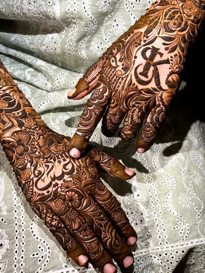A beautiful composition showing both hands, one with the initial 'K' and the other with a name in script, demonstrating the versatility of my custom designs.