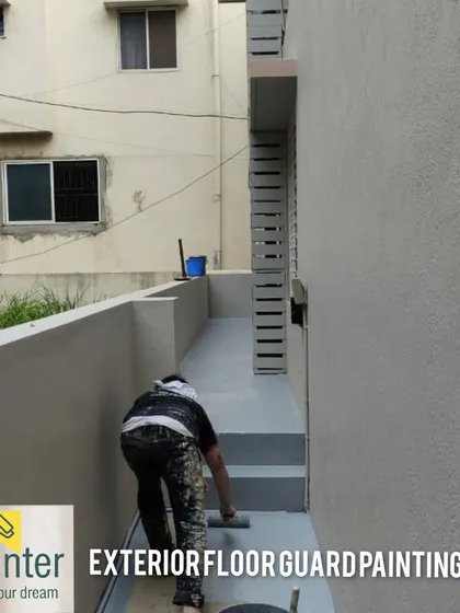 Applying exterior floor guard paint to a walkway. This specialized coating is durable, anti-slip, and protects the concrete from wear and tear.