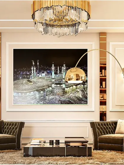 This formal living area exudes classic elegance. We paired tufted armchairs with a custom art piece depicting a sacred landmark, framed by traditional wall molding and a grand crystal chandelier to create a space of cultural significance and luxury.