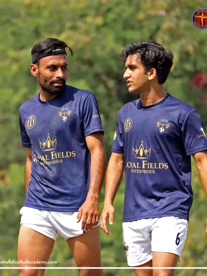 Two senior players discussing tactics during a break in play. Game intelligence and communication are as important as physical skill.